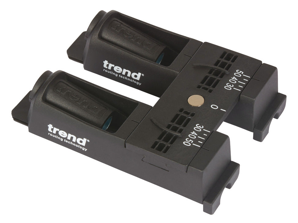 Two Trend portable electronic devices with black bodies, white branding, and a small gold button, shown on a plain white background.