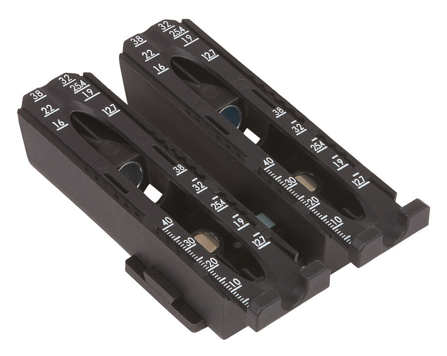 Two black plastic battery charger or battery terminal blocks with white printed polarity markings, shown on a plain white background.